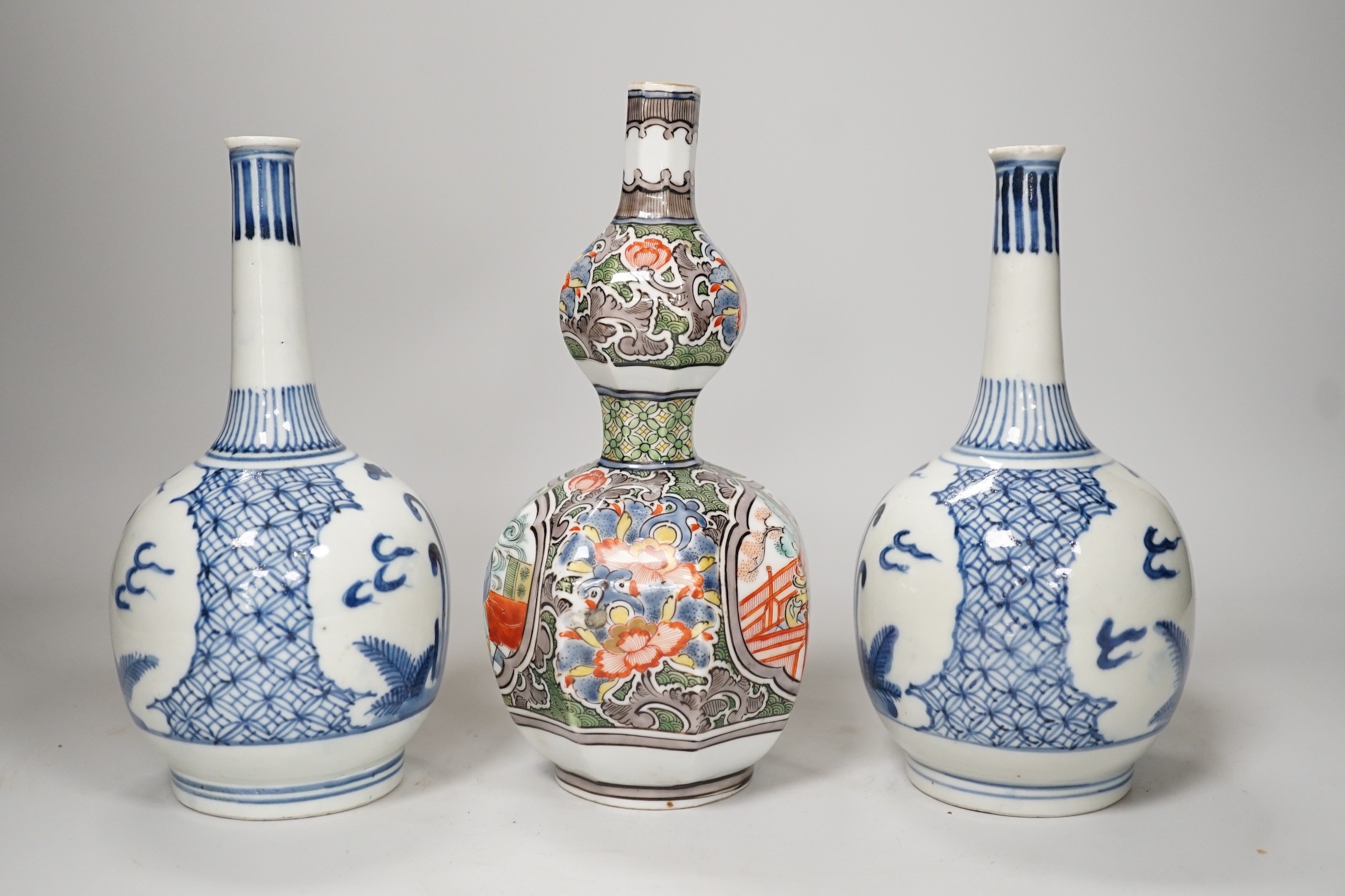 A Chinese famille verte octagonal double gourd vase, together with a pair of Chinese blue and white bottle vases, tallest 20cm